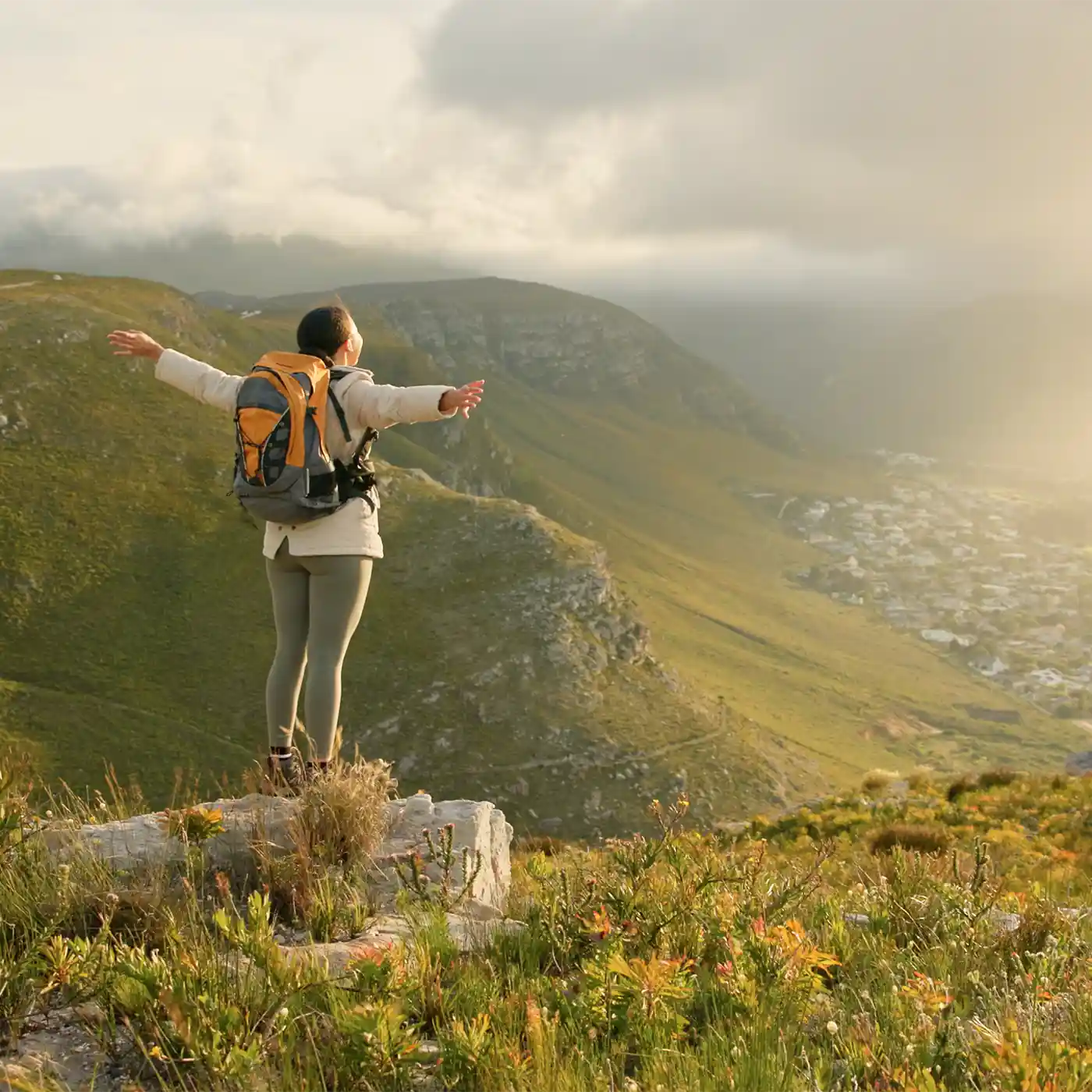 Scene from ad: Hiker stands atop a beautiful view.